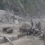 An APF officer being carried on a stretcher by rescue team after falling during a flood relief operation in Rasuwa, Nepal.