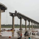 Rescue workers at the site of the collapsed bridge over the Gambhira River in Vadodara, Gujarat, India.