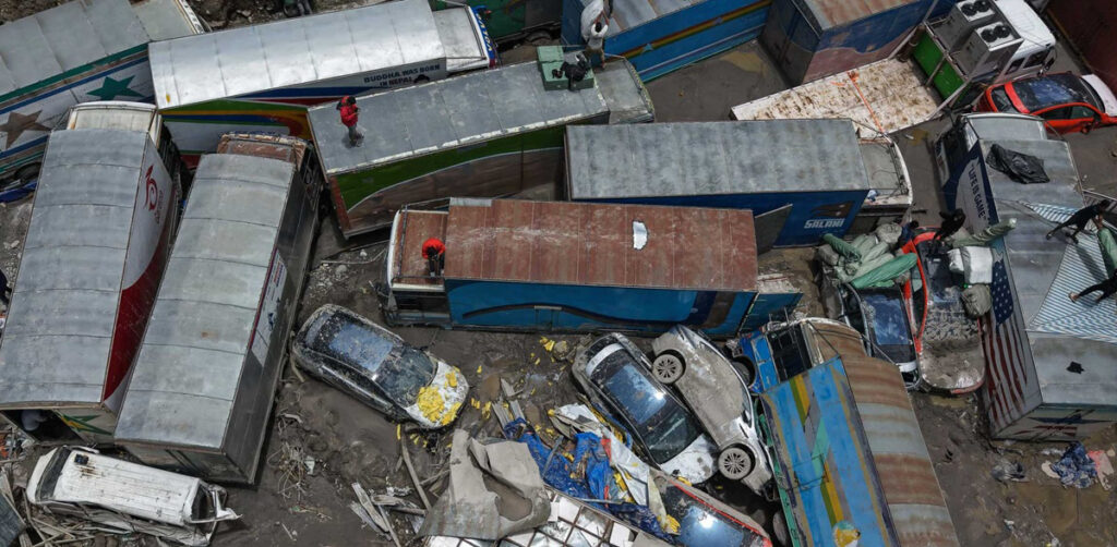 Floodwaters sweeping through the customs yard in Lhendekhola, Rasuwa, washing away electric vehicles and damaging trade infrastructure near the Nepal-China border.
