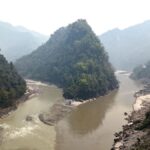 Police officers inspect the area where a male body was found along the Trishuli River in Dhading, Nepal.