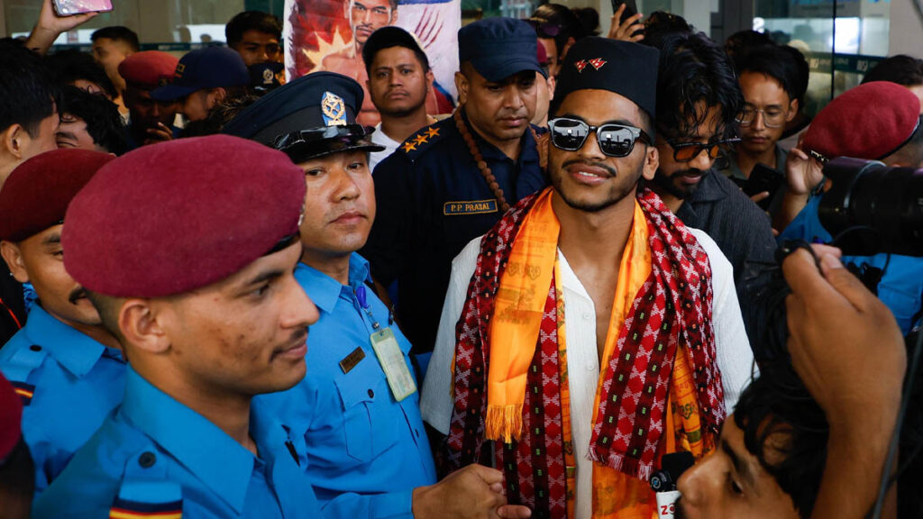 Rabindra Dhant smiles in traditional Nepali attire as he arrives at Tribhuvan International Airport after winning the MFN 17 Bantamweight Championship.