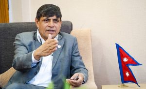 Ghanashyam Bhusal speaking during a political event while commenting on KP Sharma Oli’s participation in the upcoming election.