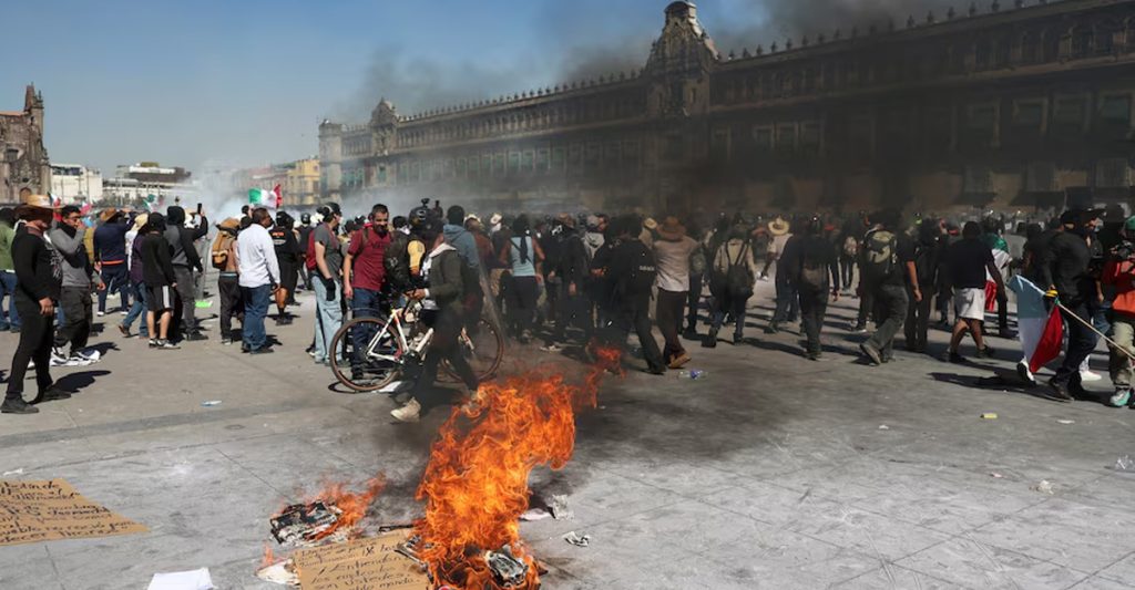 Youth protesters clashing with police during nationwide demonstrations in Mexico City over rising violence and security concerns.